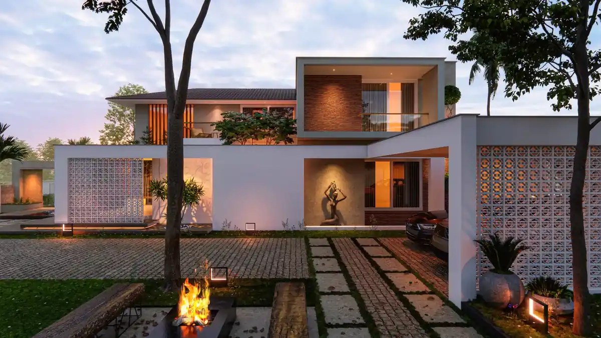 Residence at evening seen from its landscaped entrance court, with perforated screen walls, a fire pit and warm facade lighting, Menamkulam, Trivandrum