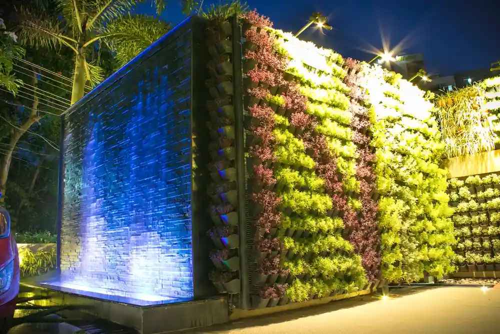 Vertical green wall with waterfall in Trivandrum - landscape design by Radianz, architects in Trivandrum