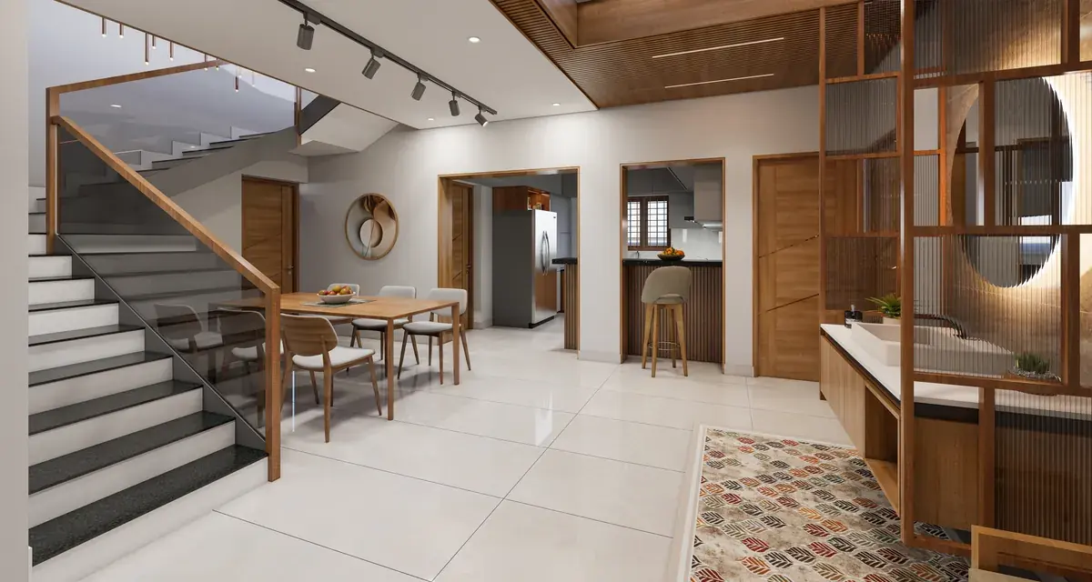 Open ground floor with a staircase, a dining table for six and a timber screen with round cut-outs beside the entrance