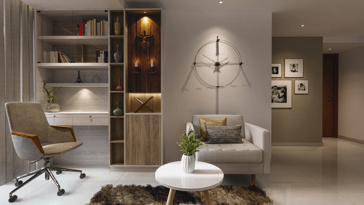 Quiet corner with a writing desk, open bookshelves, a small lit prayer niche and a reading chair